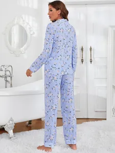 Rear view of women's two-piece light blue floral print pajama set in bathroom