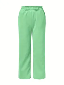 Detail of light green women's joggers with elastic waistband and comfortable relaxed fit