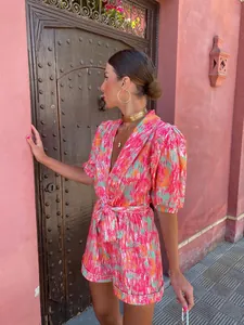 Stylish vibrant printed deep V-neck romper with puff sleeves and tie waist summer style