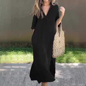 Elegant detail of a black V-neck summer dress featuring 3/4 sleeves and side slits.