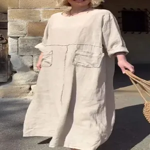 Detail view of a comfortable loose cotton linen maxi dress with large pockets in beige