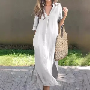 Full-length view of a white V-neck summer dress with side slits and pleated chest detail