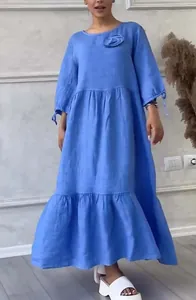 Elegant blue tiered maxi dress featuring a round neck and stylish tie-cuff sleeves