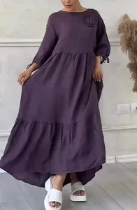 Detailed view of dark purple long-sleeved maxi dress featuring a high-low hem design