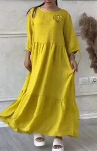 Full-length view of a casual yellow round neck tiered maxi dress with floral detail