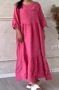 Full length view of pink long sleeve tiered maxi dress featuring a rose floral applique