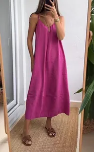 Model mirror selfie showing a loose fuchsia pink spaghetti strap maxi dress fit