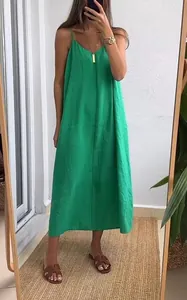 Full-length mirror selfie of a woman wearing a casual loose green summer slip dress