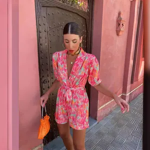 Vibrant dopamine print jumpsuit with deep V-neck and puff sleeves for stylish summer wear