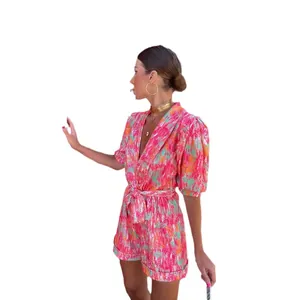 Summer romper with deep V-neck and puff sleeves featuring vibrant abstract print pattern.