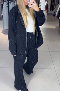 Detail view of black rhinestone hoodie and matching wide-leg pants two-piece set.