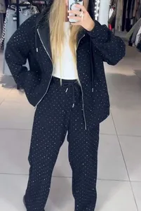 Chic black two-piece sports tracksuit set featuring sparkling rhinestone embellishments