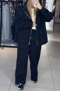 Close-up detail of the black rhinestone-studded hoodie and wide-leg tracksuit set for women