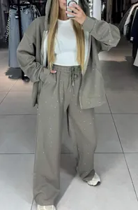 Women's grey zip-up hoodie and wide-leg pants set with sparkling rhinestone details