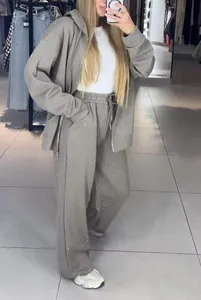 Detail of gray rhinestone tracksuit set with zip-up hoodie and wide leg sweatpants