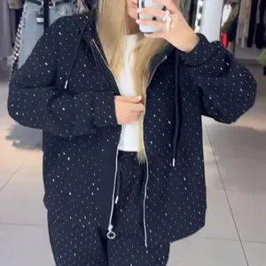Detail view of women's black rhinestone studded zip-up hoodie and pants set