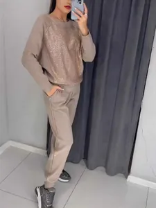 Casual women's two-piece tracksuit featuring a rhinestone crewneck top and jogger pants