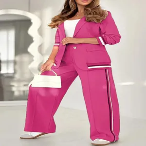 Detailed view of pink two-piece blazer suit with sporty striped ribbing detail