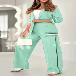 Mint green two-piece elegant office suit with blazer and ribbed wide-leg trousers