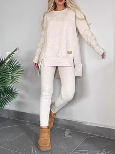 Casual women's two-piece lounge set with side slit top and matching leggings in oatmeal