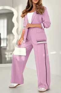 Detail shot of purple 2-piece suit with striped ribbed trim and wide-leg pants.