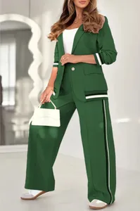 Elegant green two-piece women's suit with striped ribbed details and wide-leg trousers.