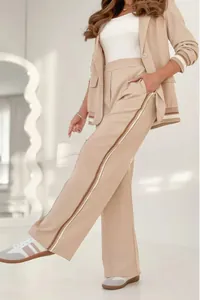 Detail view of a chic beige two-piece commuting suit with side-stripe trousers