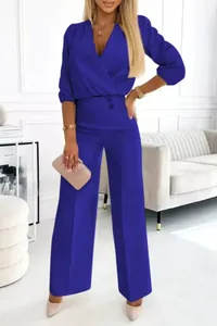 Elegant royal blue two-piece set with V-neck wrap top and wide-leg trousers detail.