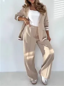 Elegant beige two-piece office suit featuring blazer with striped ribbing and wide-leg pants.