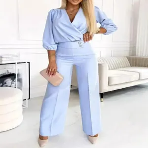 Elegant light blue two-piece set featuring V-neck wrap top and matching wide-leg trousers