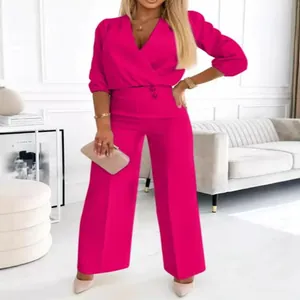 Elegant fuchsia two-piece set featuring a V-neck top and high-waist wide-leg trousers