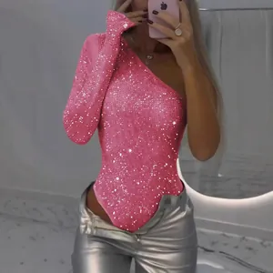 Glamorous pink one-shoulder sequin bodysuit featuring long sleeves and sparkly rhinestones