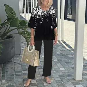 Casual two-piece set with a floral print mid-sleeve top and black trousers for women.