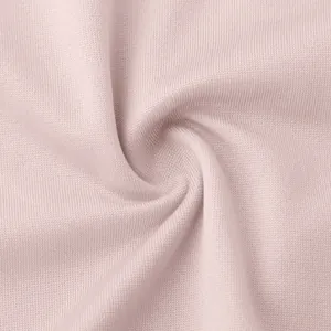Macro view showing the soft pink knitted fabric texture of women's two-piece dress
