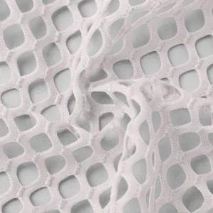 Macro view of soft white knitted mesh fabric showing detailed hollow-out square texture