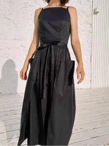 Elegant sleeveless black sun dress with waist tie and pockets for summer fashion