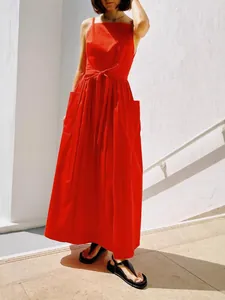 Elegant red sleeveless sun dress with waist tie and pockets for summer fashion