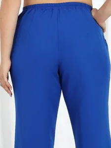 Back view detail of vibrant royal blue loose casual chiffon pants with elastic waist.