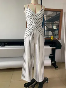 White and black striped two-piece set with V-neck wrap top and wide-leg trousers.