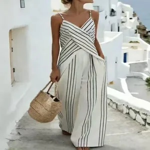 Detailed view of a white and black striped sleeveless jumpsuit with cross-over V-neck design.