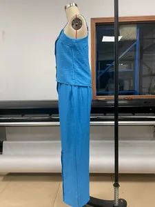 Side view of blue two-piece set with side-button camisole and wide-leg pants.