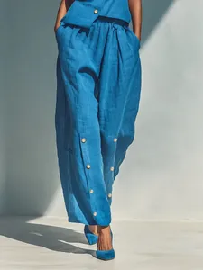 Stylish blue two-piece set featuring diagonal button top and wide-leg trousers outfit
