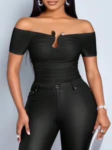 Close-up of elegant black off-the-shoulder ruched top with metallic buckle detail