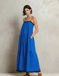 Detailed front view of a long blue spaghetti strap dress with chic black trim accents