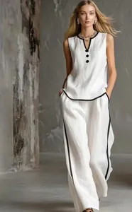 Elegant white sleeveless V-neck top with black piping and matching wide-leg trousers set