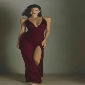 Detailed shot of an elegant wine red satin maxi dress with a high slit and deep V-neckline