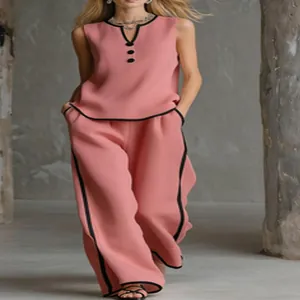 Elegante set rosa top senza maniche scollo a V e pantaloni larghi con bordo nero a contrasto