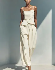 Elegant cream two-piece set featuring a diagonal button camisole and matching wide-leg trousers