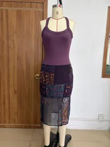 Detailed front view of purple ribbed bodice and digital print patchwork mesh dress
