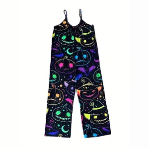 Women's Halloween holiday jumpsuit featuring neon pumpkin and witch hat prints on black